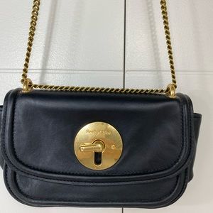 See by Chloe black leather purse with gold accenting and chain strap